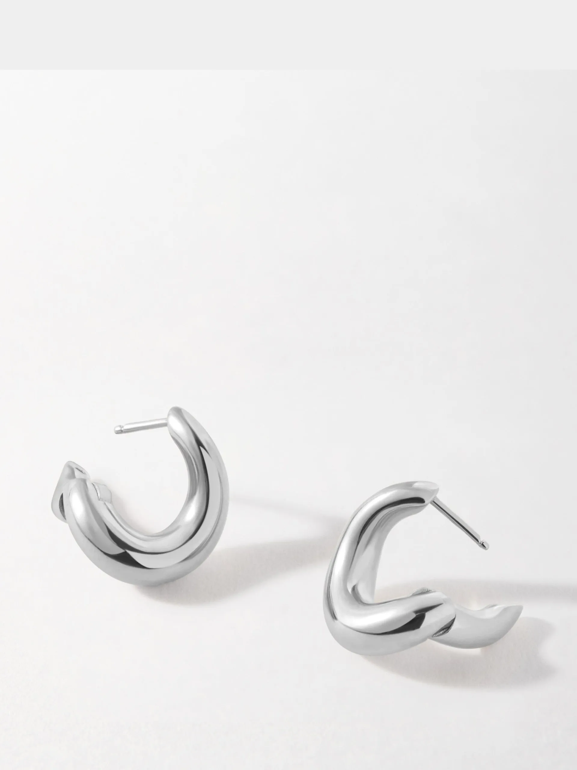 Charlotte Collins twist hoop earrings in silver
