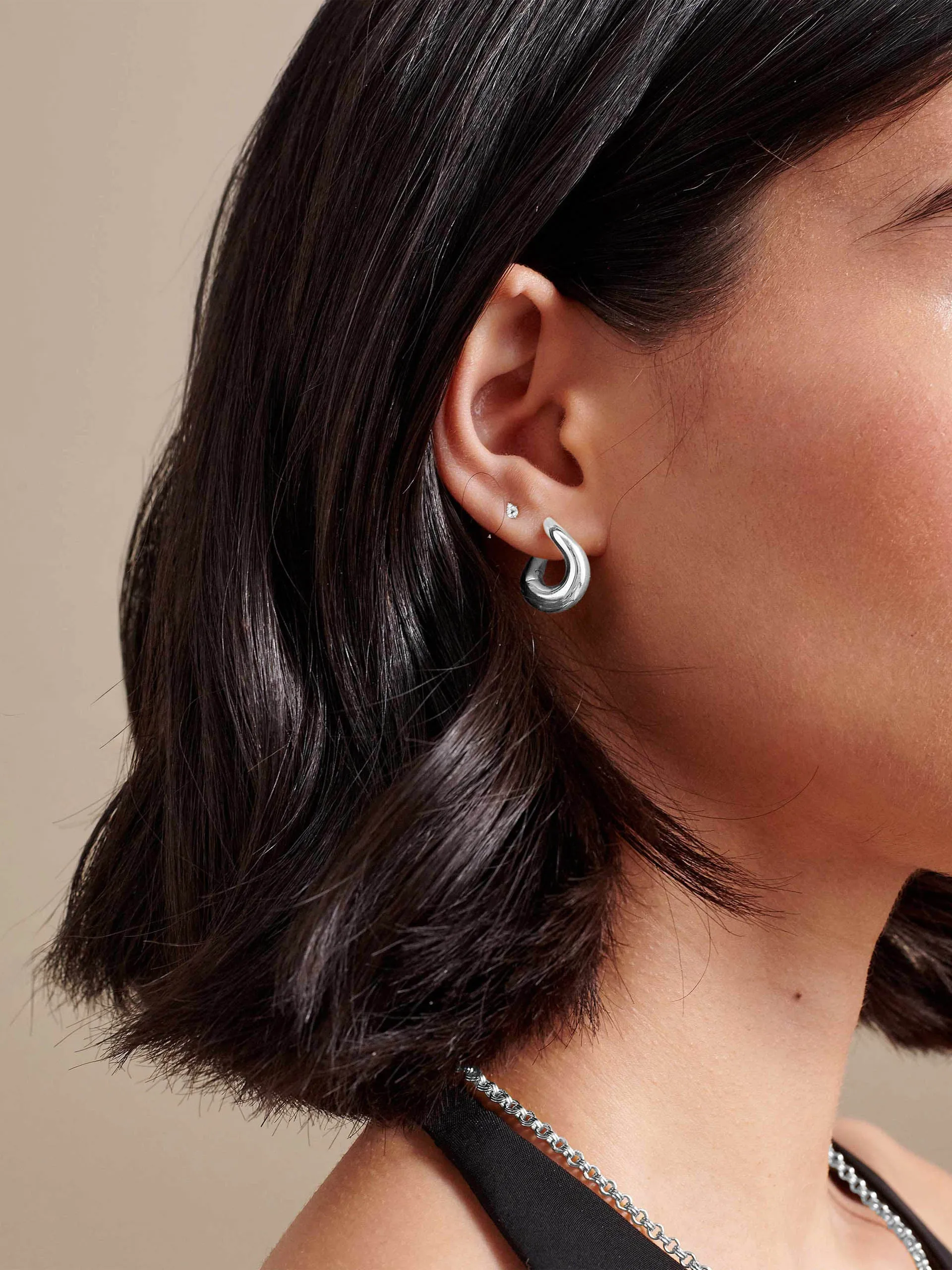 Charlotte Collins twist hoop earrings in silver